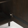 Close up of the metal door hinge and interior finish on the dark cabinet