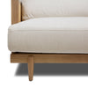 Low-angle perspective of the Unio chair highlighting the tapered oak legs and woven cane detailing.