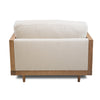 Angled rear view showing the wrap-around cane paneling and the minimalist aesthetic of the chair.