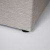 Detailed view of the seamless bed frame corner highlighting the high-quality sand fabric weave and plush cushioning