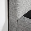 Perspective shot of the bed base focusing on the high-quality tailoring and seamless fabric transitions