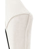 Detailed view of the headboard edge showcasing the elegant piping detail and the soft tactile fabric weave