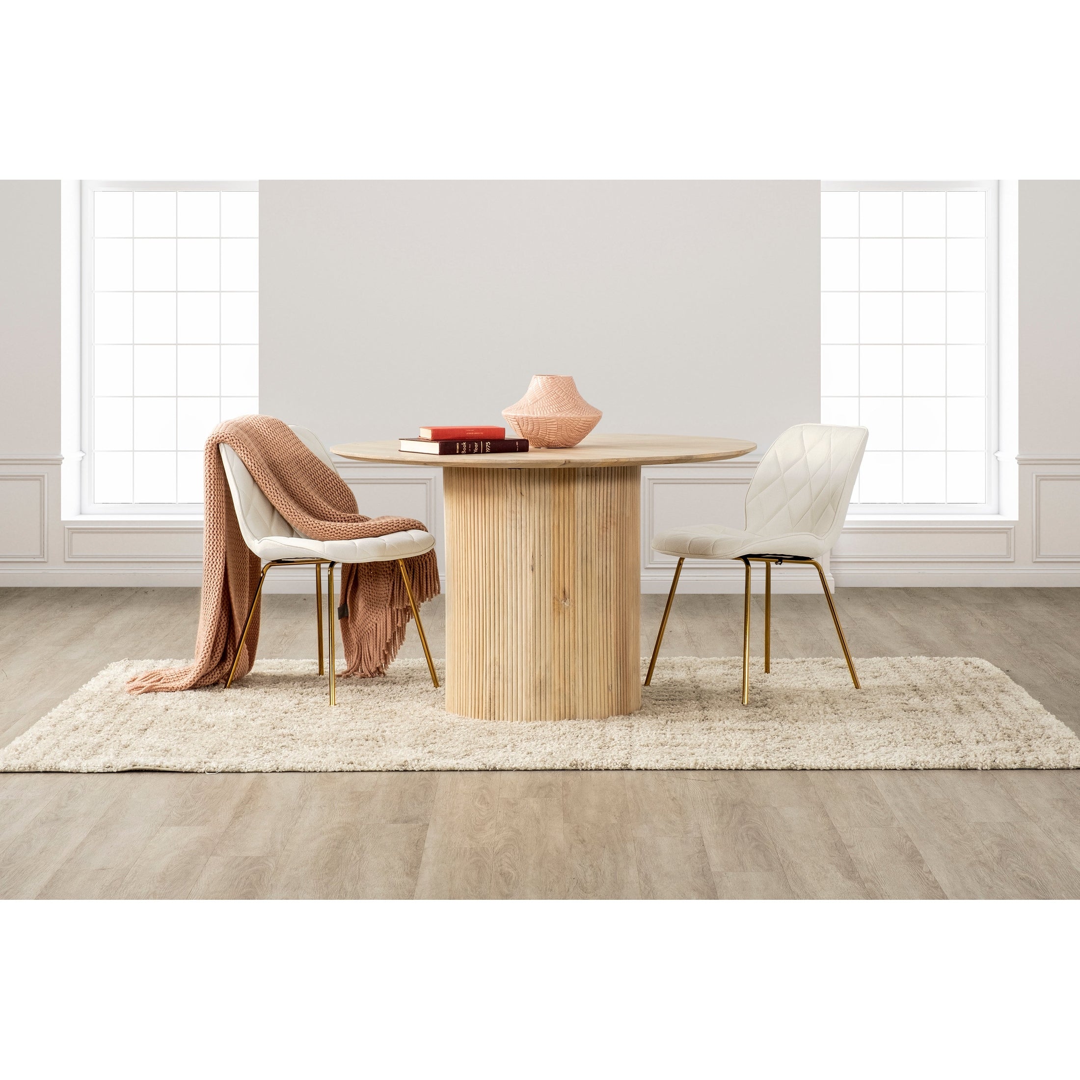 Front view of the Valdemar round dining table featuring a natural oak wood finish and a striking cylindrical fluted pedestal base