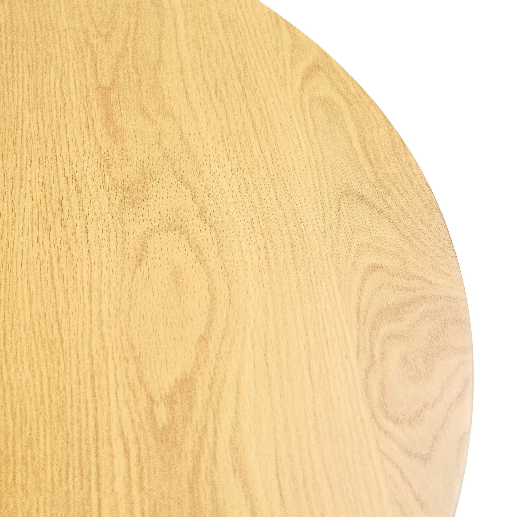 Front view of the Valdemar round dining table featuring a natural oak wood finish and a striking cylindrical fluted pedestal base