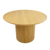 Front view of the Valdemar round dining table featuring a natural oak wood finish and a striking cylindrical fluted pedestal base