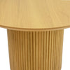 Close-up perspective focusing on the smooth oak tabletop surface meeting the vertical ribbed texture of the fluted base