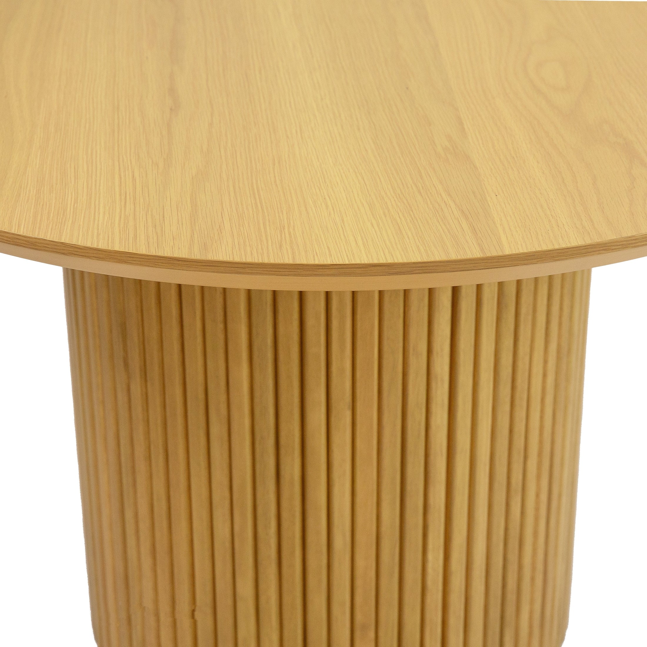 Front view of the Valdemar round dining table featuring a natural oak wood finish and a striking cylindrical fluted pedestal base
