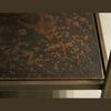 Close-up shot focusing on the hand-applied distressed texture and mottled patina of the antique brass frame edge