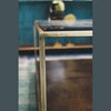 Interior view showing the coffee table styled with a decorative vase in a minimalist room with soft neutral tones
