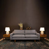 Lifestyle perspective showcasing the nightstand used as a side table next to a contemporary gray sofa and modern lamps