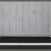 Close-up shot of the headboard showcasing the symmetrical vertical channel stitching and plush padding