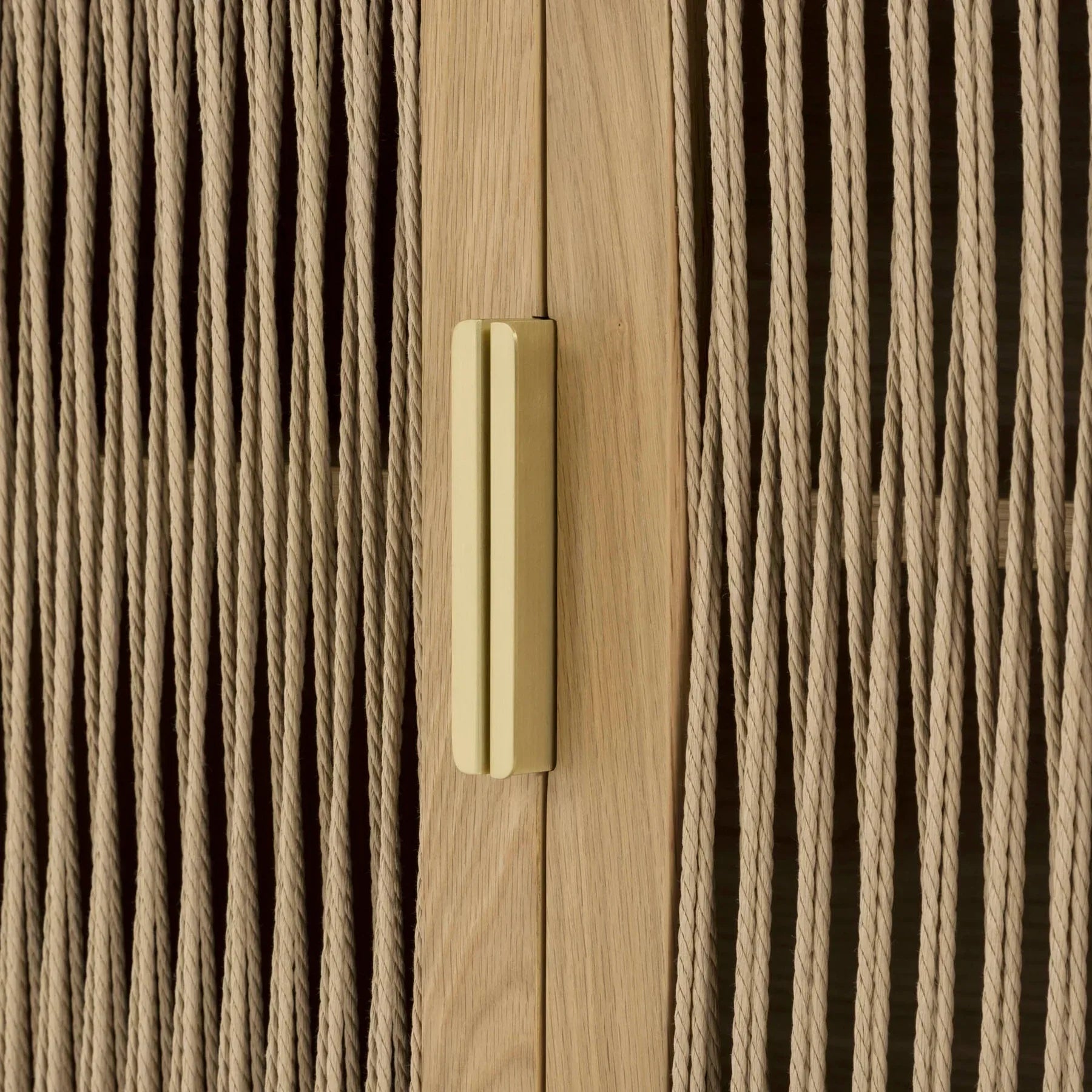 Front perspective view of the Lumina 4-door sideboard featuring a light oak wood frame, fluted glass door panels, and elegant vertical gold metal handles