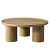 Front view of the Viggo round coffee table featuring a natural wood finish and three chunky cylindrical pedestal legs