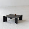 High-angle lifestyle shot of the Vito coffee table styled with a single candle in an airy contemporary space