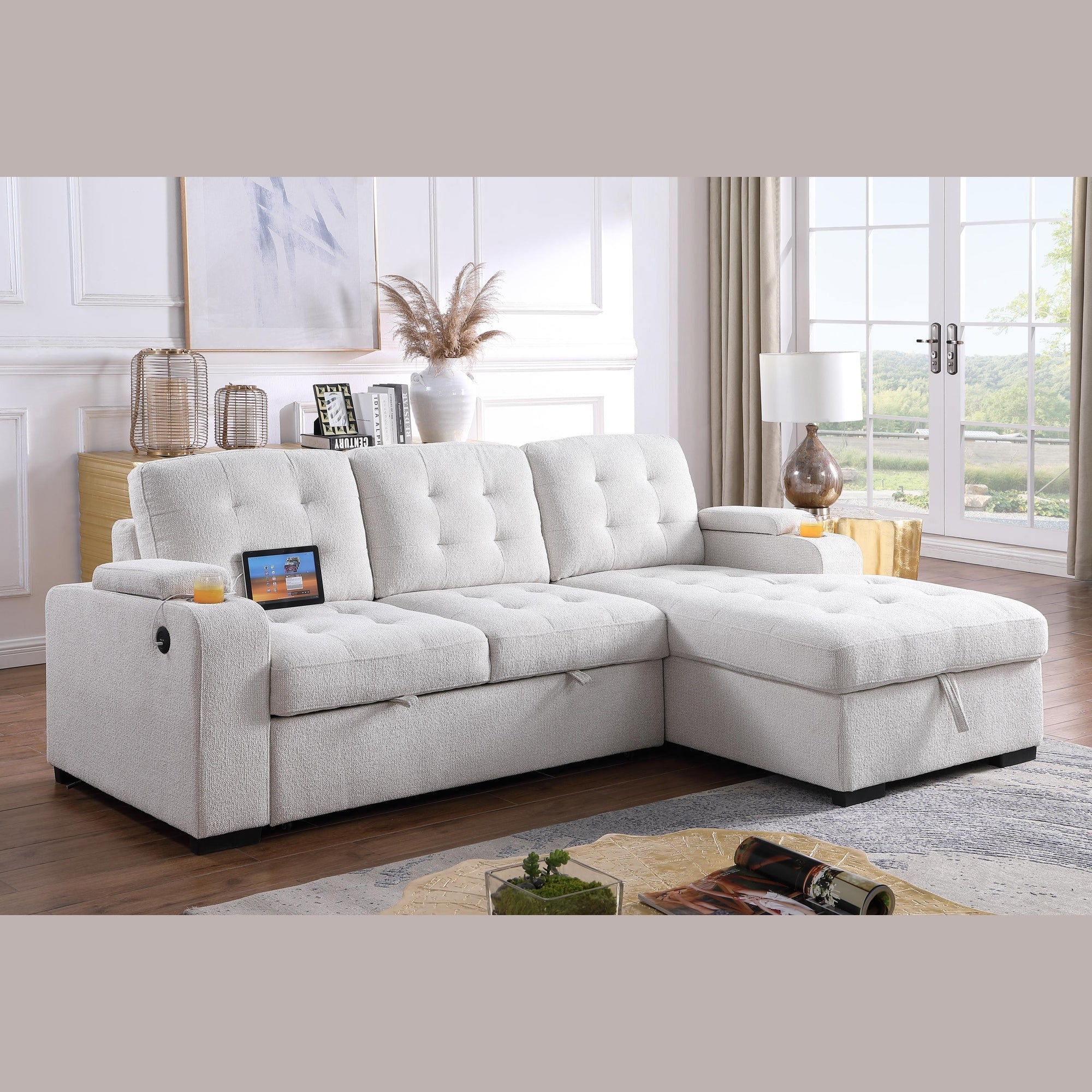 Angled view of the Voss Media Sleeper Sectional in grey showing the pull-out bed extended and open storage chaise