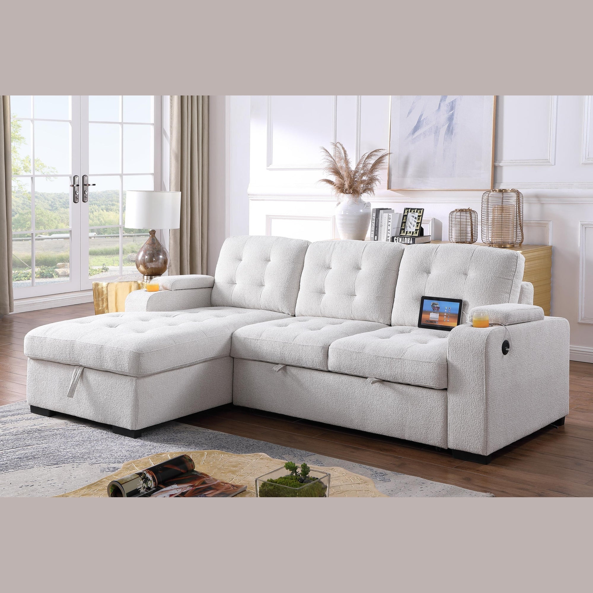 Angled view of the Voss Media Sleeper Sectional in grey showing the pull-out bed extended and open storage chaise