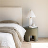 Lifestyle view showcasing the headboard under warm ambient light highlighting the depth of the fabric texture