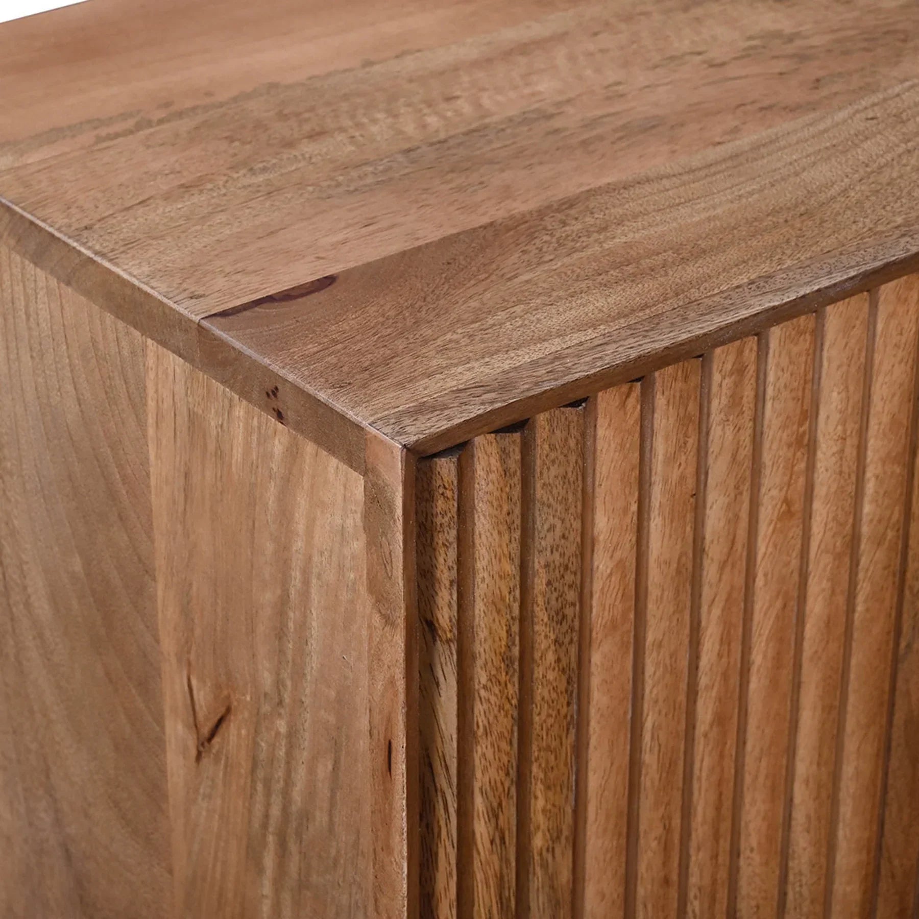 Front view of the Nikita sideboard featuring a warm wood finish with intricate chevron-patterned ribbed door panels and slim black metal legs