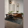 Wide-angle shot of the sideboard in a bright dining room highlighting its organic texture and mid-century aesthetic