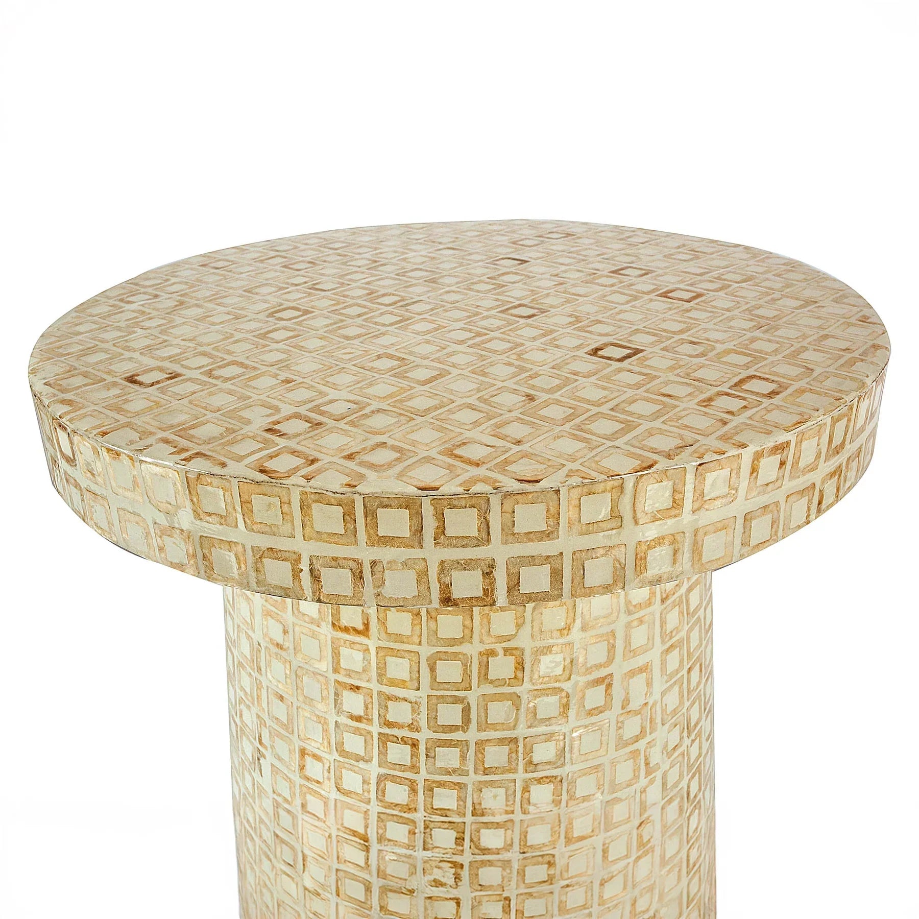 Three-quarter view of the Waterlily side table featuring a circular top and cylindrical pedestal base covered in a geometric cream capiz shell mosaic