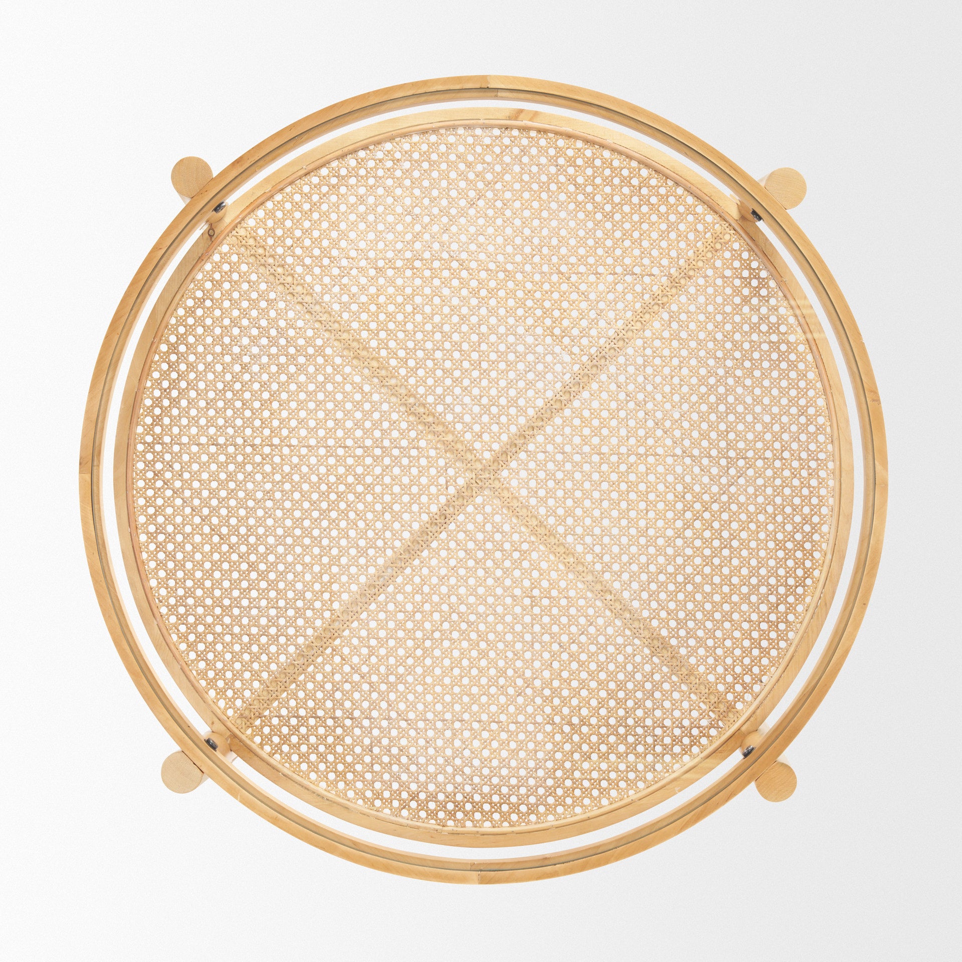 Front view of the Weslyn coffee table featuring a circular glass top and a natural woven cane lower storage shelf