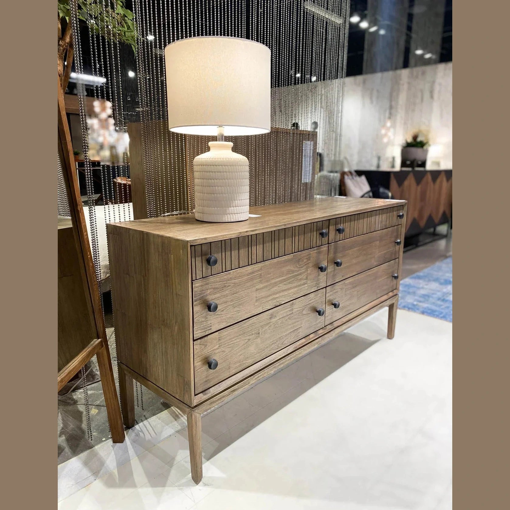 Front view of the West 6-drawer double dresser featuring a rich natural wood finish, dark circular knobs, and top drawers with vertical fluted detailing