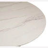 Close-up perspective focusing on the natural organic patterns and smooth polished surface of the white marble tabletop