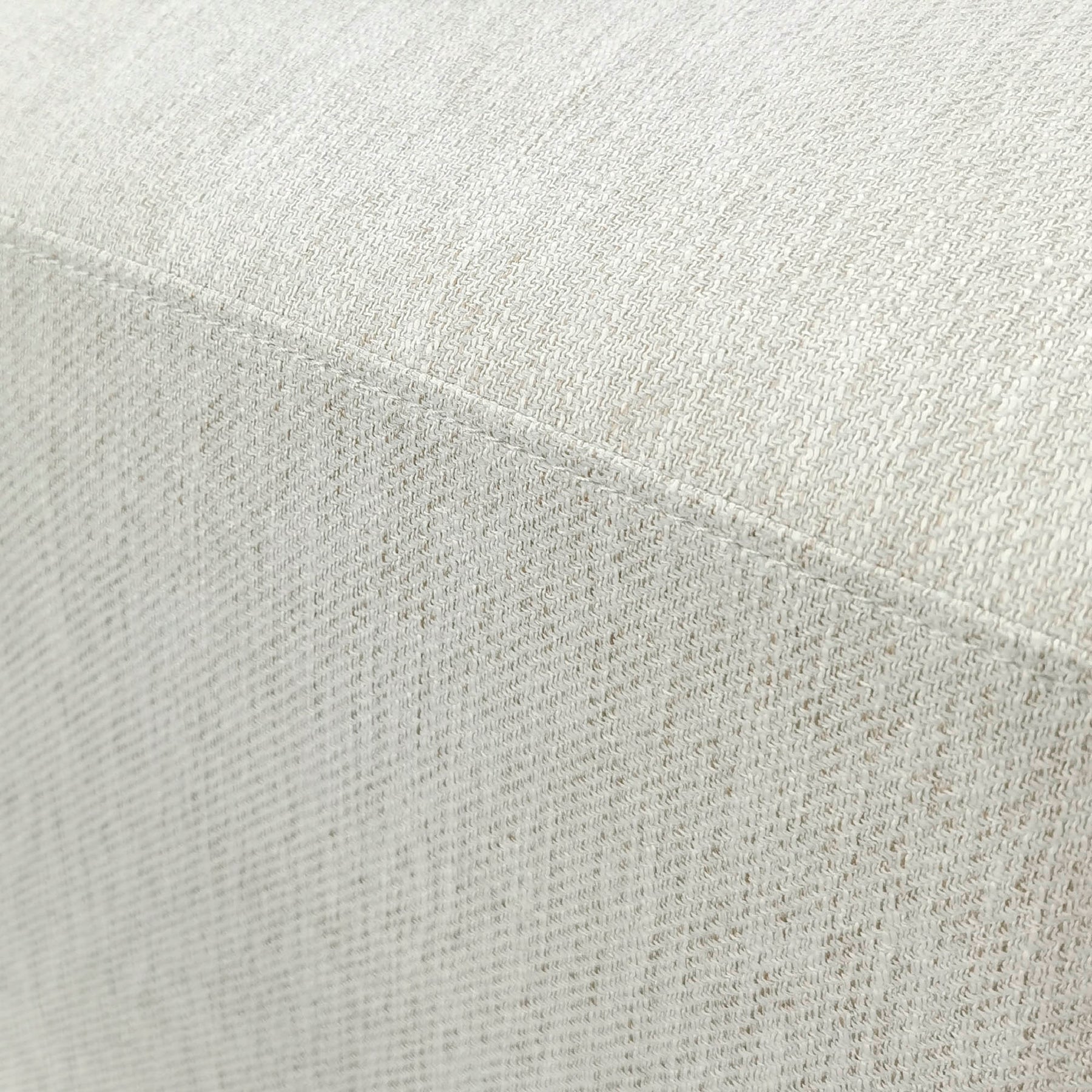 Macro view of the white multi-tonal textured upholstery used for the Romer collection