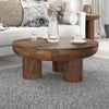 High-angle lifestyle shot of the Wilder coffee table styled with a water carafe and white sofa in a bright interior