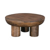 Front view of the Wilder round coffee table featuring a thick solid wood top and three chunky cylindrical pedestal legs