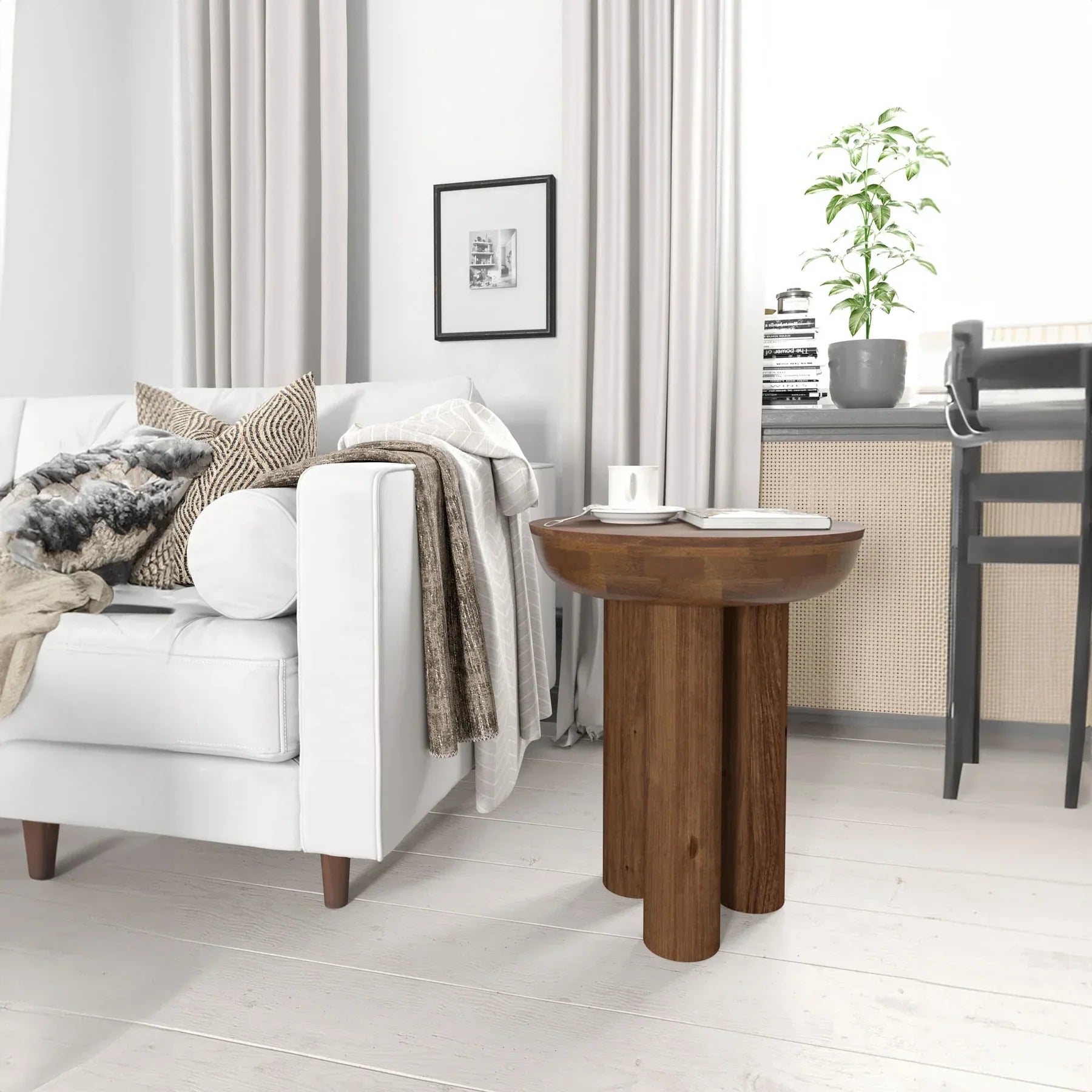 Lifestyle view of the Wilder table styled as a minimalist nightstand in a bright bedroom setting next to a white bed