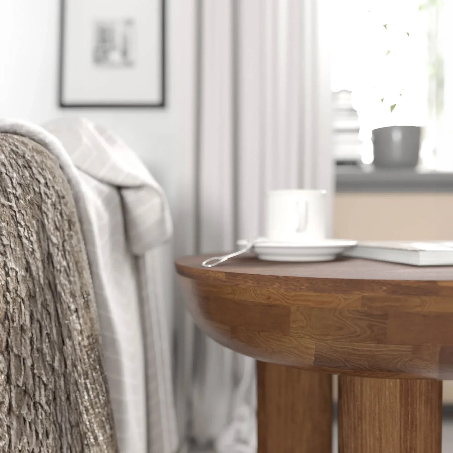 Lifestyle view of the Wilder table styled as a minimalist nightstand in a bright bedroom setting next to a white bed