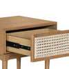 Close-up view of the white woven cane inlay on the drawer front featuring a smooth handle-free push-to-open design