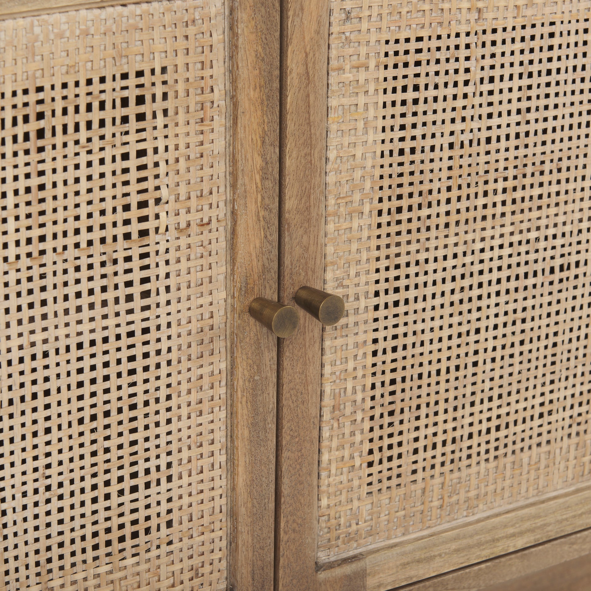 Macro shot focusing on the high-quality woven rattan texture and natural color variations of the cabinet door inserts