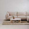 Lifestyle shot featuring the Wunder coffee table styled in a bright minimalist living room on a plush shag rug