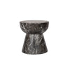 Three-quarter view of the Yves side table featuring a sculptural hourglass silhouette crafted from dark charcoal marble with prominent white veining