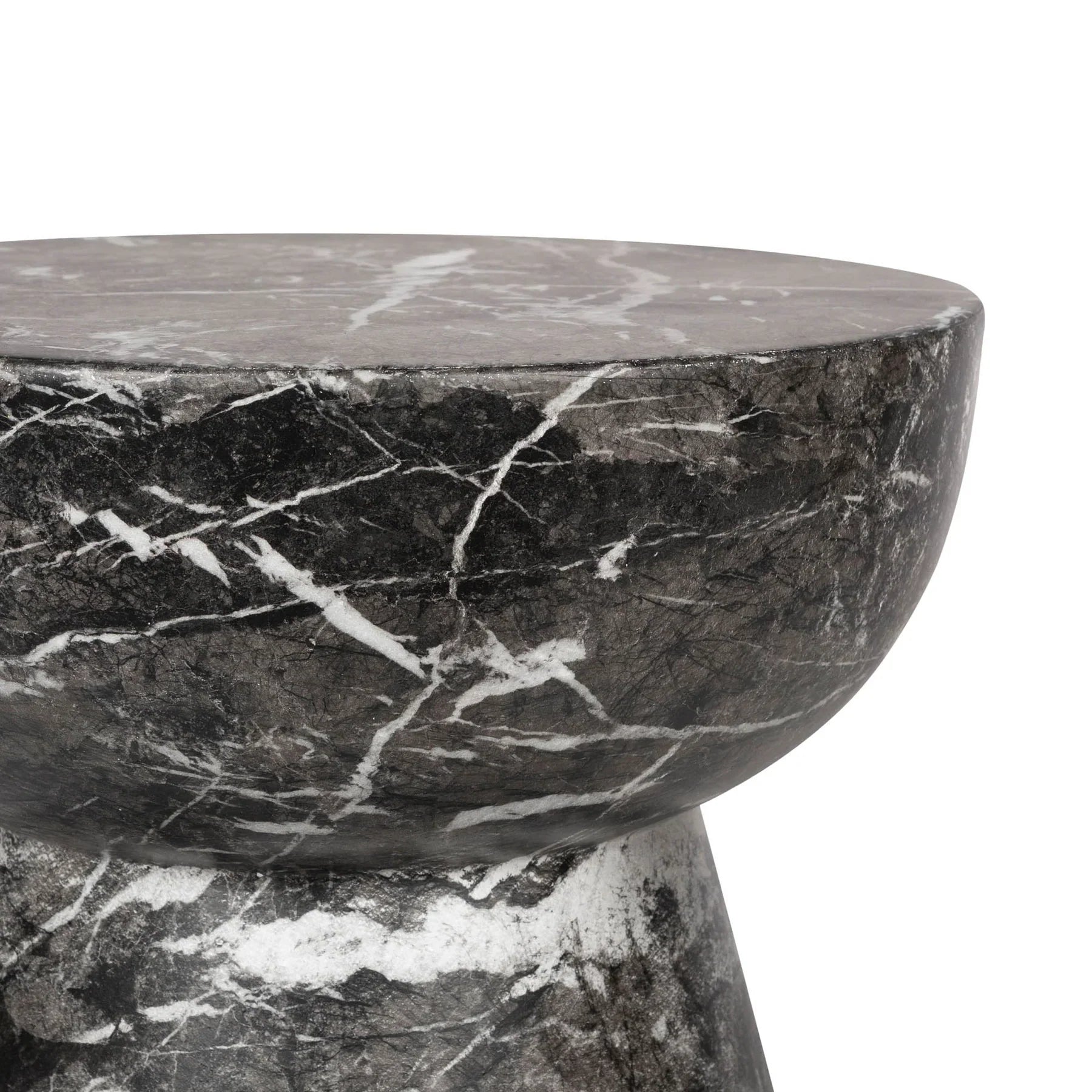 Three-quarter view of the Yves side table featuring a sculptural hourglass silhouette crafted from dark charcoal marble with prominent white veining