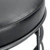 Close-up macro shot focusing on the smooth finish and quality stitching of the black leather seat