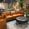 Wide lifestyle view showcasing the Ziggy ottoman as a central coffee table element in a contemporary living space