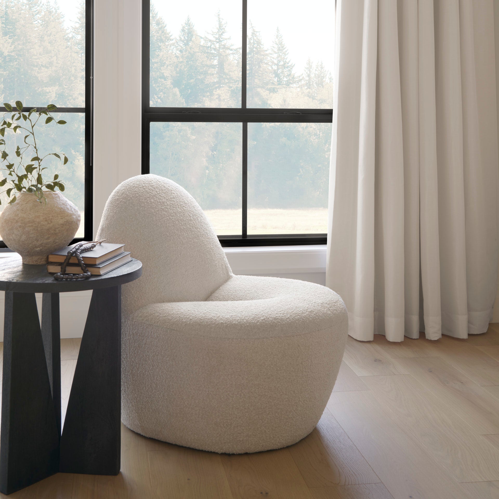 Front view of the Beverly high-back accent chair in oatmeal bouclé fabric with a sculptural pebble silhouette.