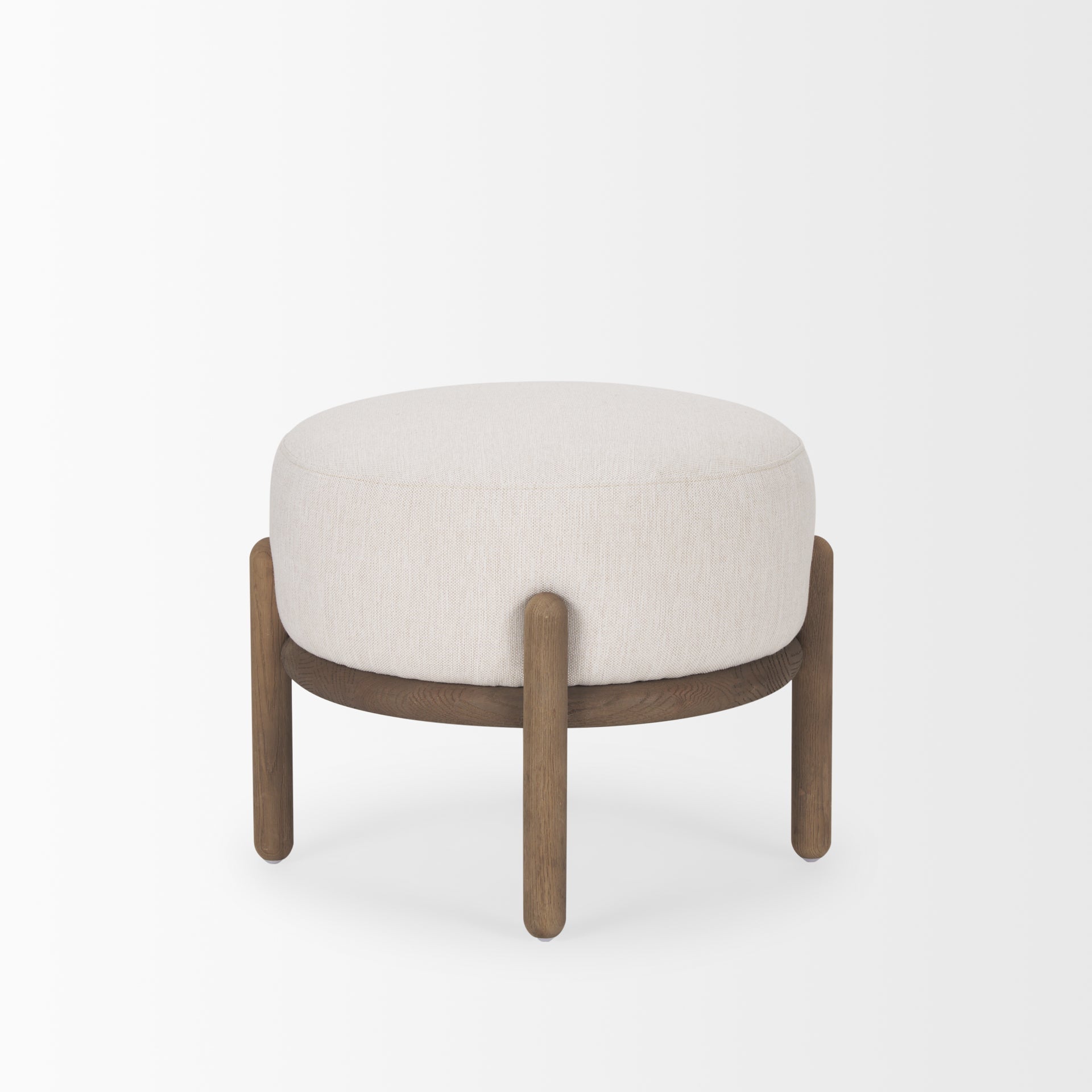 Front three-quarter view of the Gwynn pouf featuring a cream upholstered seat and a curved oak wood frame