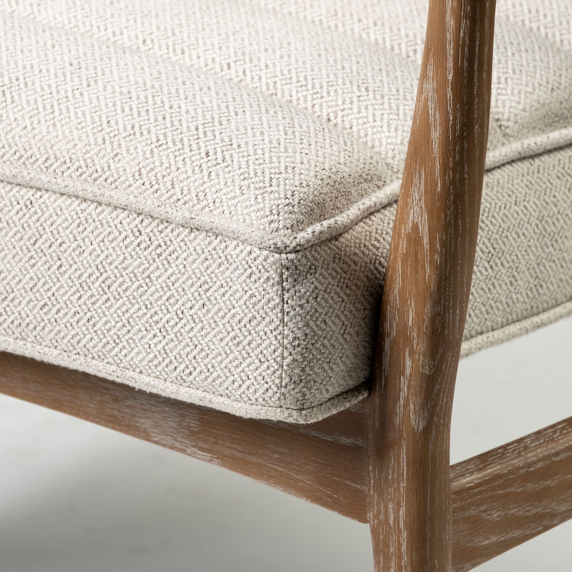 Front view of the Ajax Accent Chair in white textured fabric with a natural oak wood frame