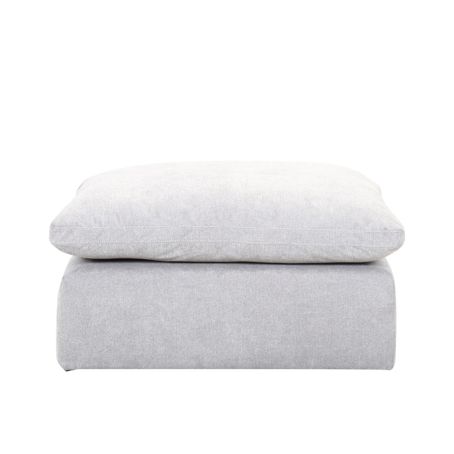 Side profile view highlighting the thick cushioned top and the low-profile modular base of the Alex ottoman