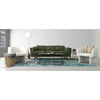 Wide lifestyle shot featuring two Ariana chairs paired with a green modular sofa and a textured rug