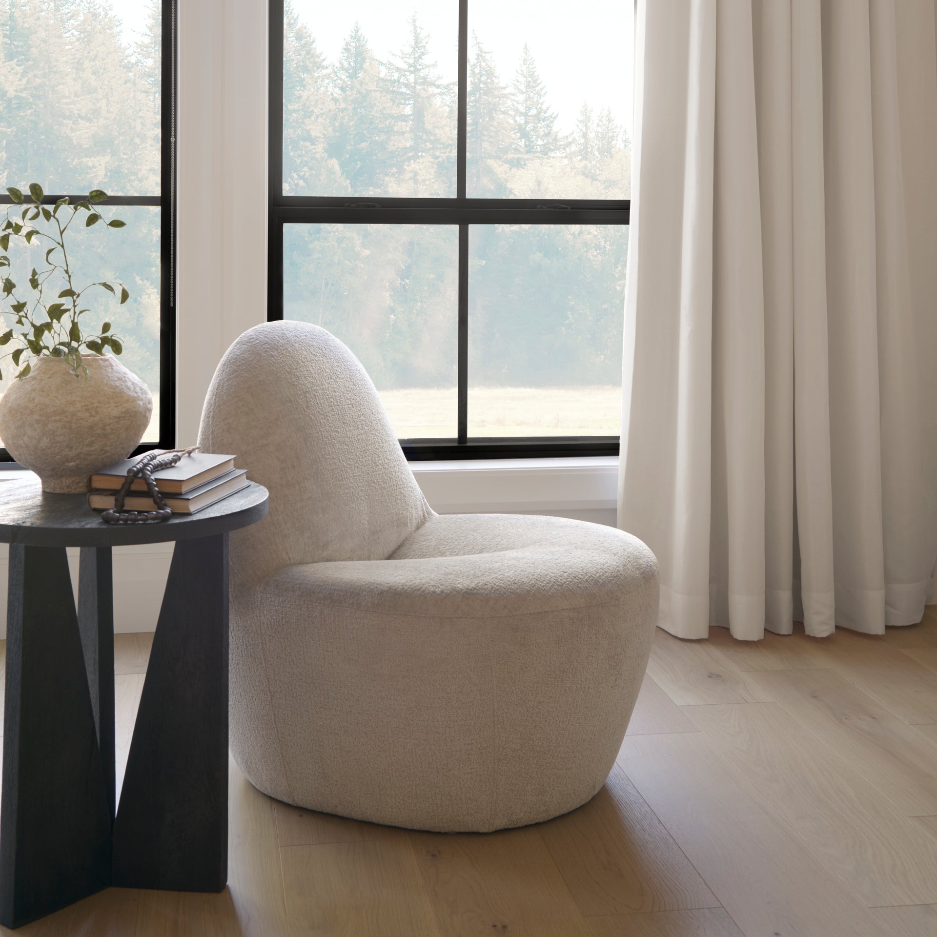 Front view of the Beverly high-back accent chair in oatmeal bouclé fabric with a sculptural pebble silhouette.