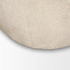 Close-up shot focusing on the lower base seam and the dense texture of the oatmeal upholstery.