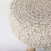 Macro detail shot focusing on the intricate loops and chunky texture of the hand-knitted gray wool