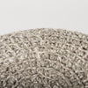 Close-up view of the stool's edge highlighting the consistent quality of the artisanal wool knit