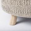 Low-angled close-up showing the secure connection point between the natural wood leg and the knitted seat base
