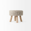 Front-facing low-angle shot showcasing the compact size and decorative appeal of the Bina knitted stool